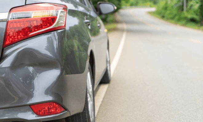 back of gray car get damaged from accident on the road. vehicle bumper dent broken by car crash. road accidents and car insurance concept@2x min