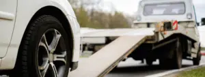 loading broken car on a tow truck on a roadside min